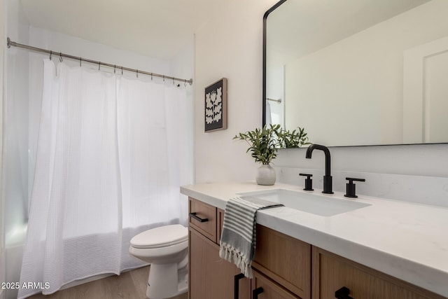 full bath with vanity, shower / tub combo, toilet, and wood finished floors