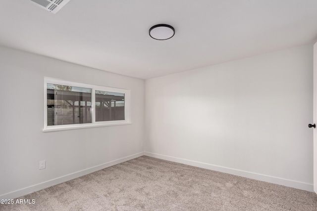 empty room featuring visible vents, carpet, and baseboards