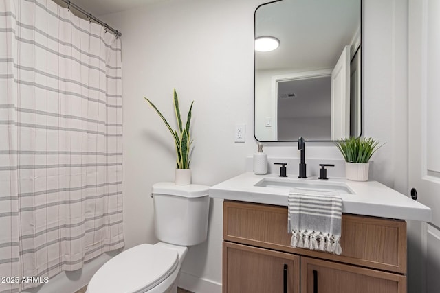 bathroom with vanity, toilet, and visible vents