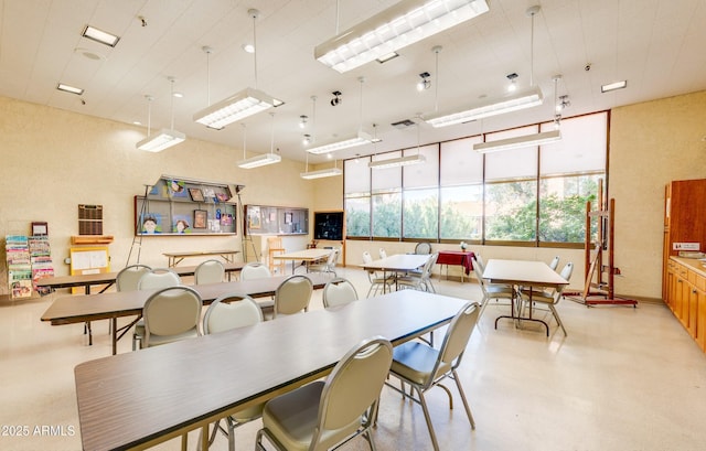 dining area featuring concrete floors and visible vents