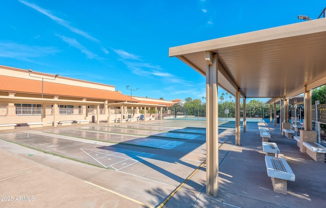 view of home's community featuring shuffleboard and fence