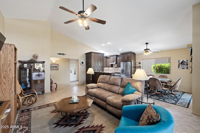 living room featuring light tile patterned floors, high vaulted ceiling, ceiling fan, and visible vents