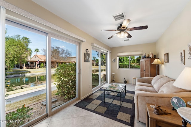 sunroom / solarium with a ceiling fan and visible vents