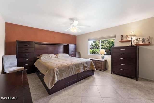 bedroom featuring a ceiling fan, baseboards, and light tile patterned floors