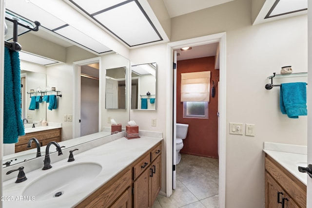 bathroom with vanity, toilet, and tile patterned floors