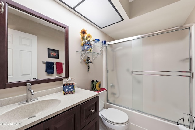 full bath with toilet, shower / bath combination with glass door, and vanity