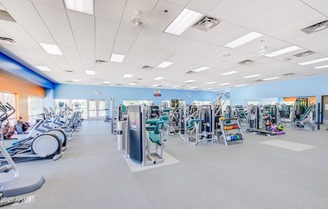 gym featuring a paneled ceiling and visible vents