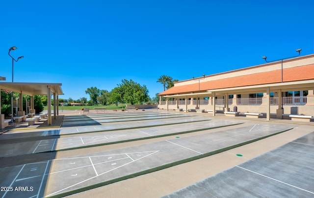 surrounding community featuring fence and shuffleboard