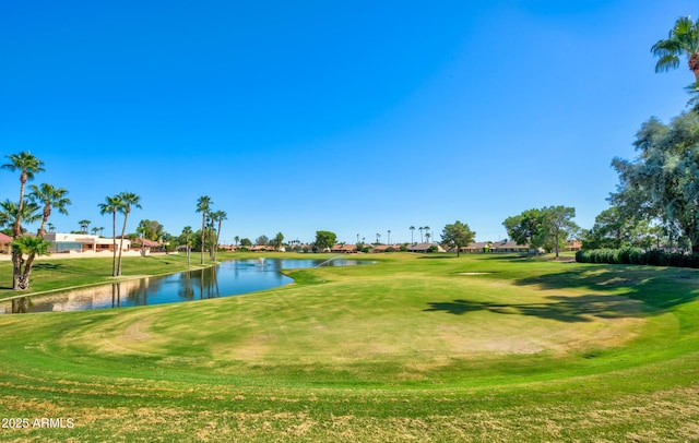 surrounding community with a water view and a lawn
