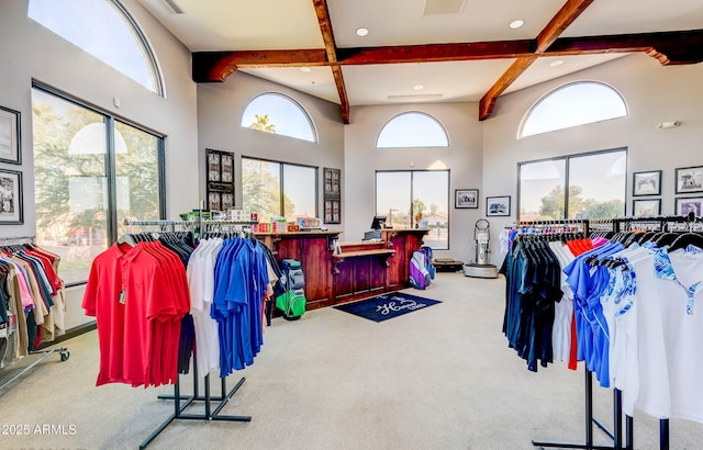 miscellaneous room featuring a high ceiling, coffered ceiling, beam ceiling, and light colored carpet