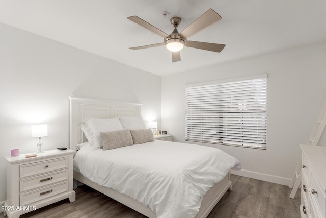 bedroom with a ceiling fan, baseboards, and wood finished floors