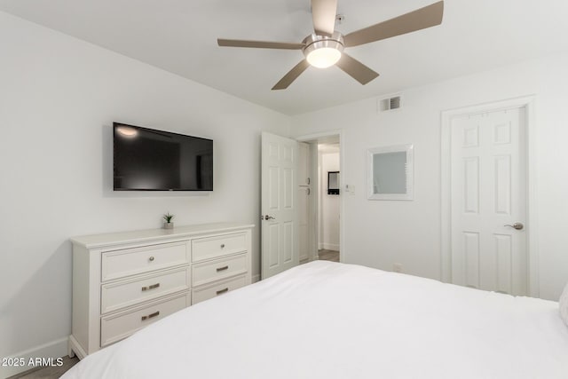 bedroom featuring a ceiling fan, visible vents, and baseboards