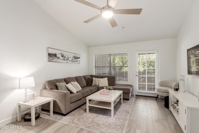 living room featuring vaulted ceiling, light wood finished floors, and ceiling fan