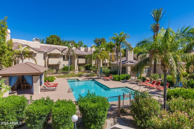 pool featuring a residential view, fence, and a patio