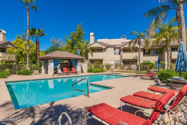 pool featuring a patio area, fence, and a gazebo