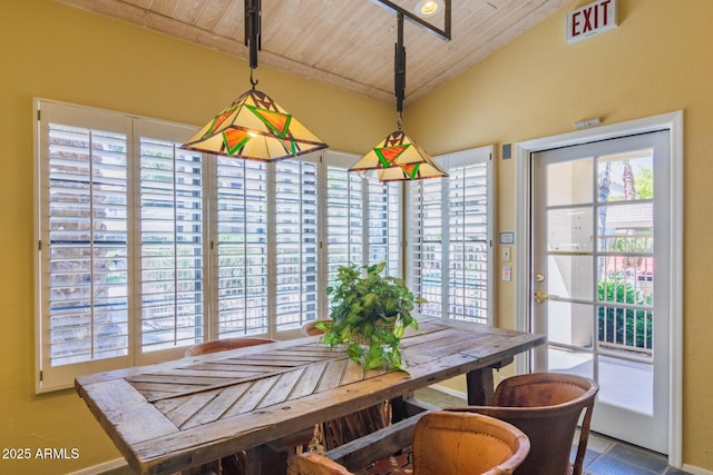 dining room featuring a healthy amount of sunlight, wooden ceiling, and lofted ceiling