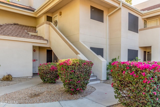 entrance to property featuring stucco siding