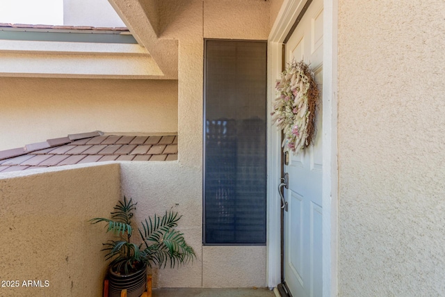 doorway to property with stucco siding