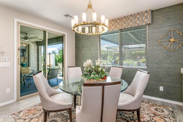 dining room with ceiling fan with notable chandelier