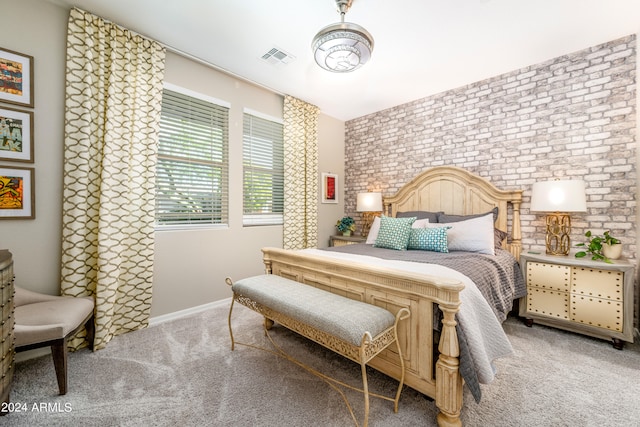 carpeted bedroom with brick wall