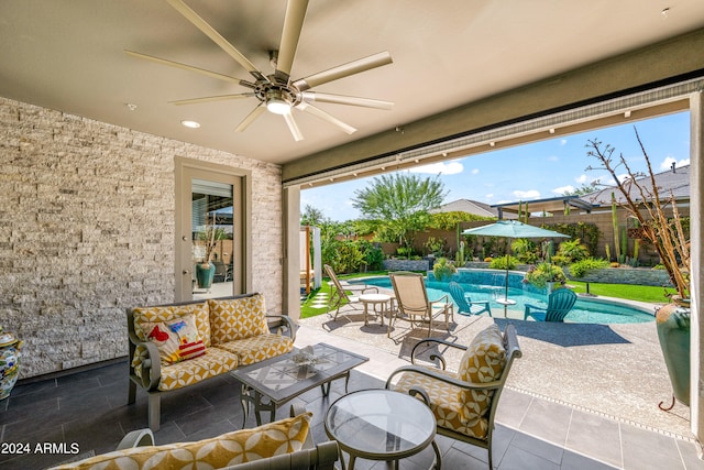 view of patio / terrace with outdoor lounge area, ceiling fan, and a fenced in pool