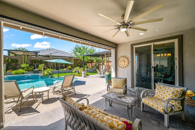 view of patio / terrace featuring a fenced in pool, ceiling fan, and pool water feature