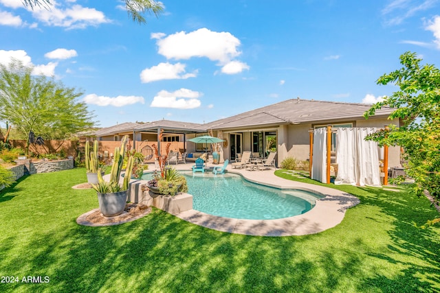 view of pool with a yard and a patio