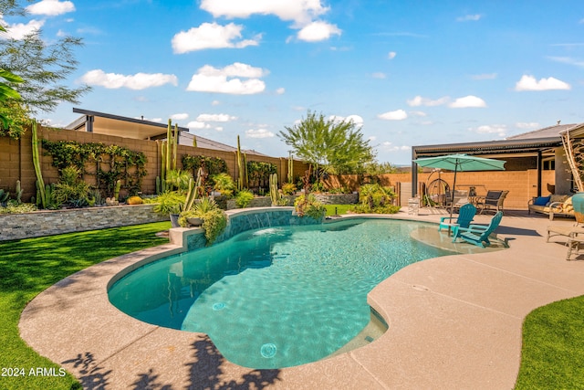 view of swimming pool with pool water feature and a patio