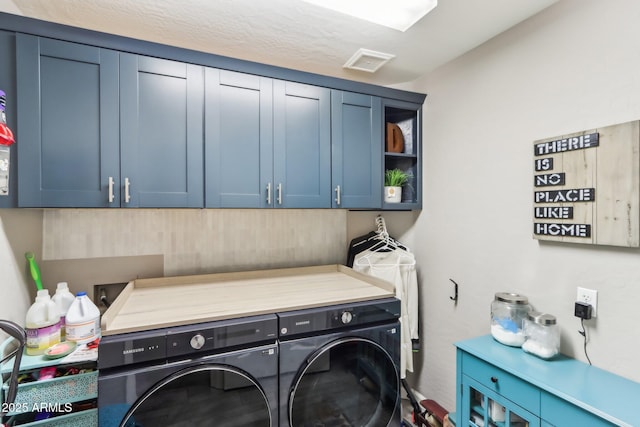 clothes washing area featuring cabinets, washing machine and dryer, and sink