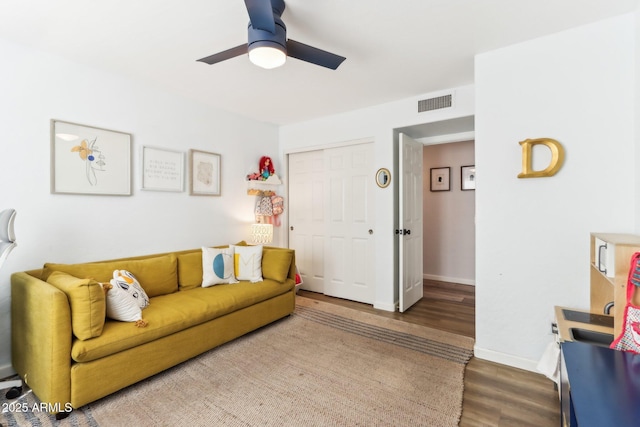 living room featuring hardwood / wood-style flooring and ceiling fan