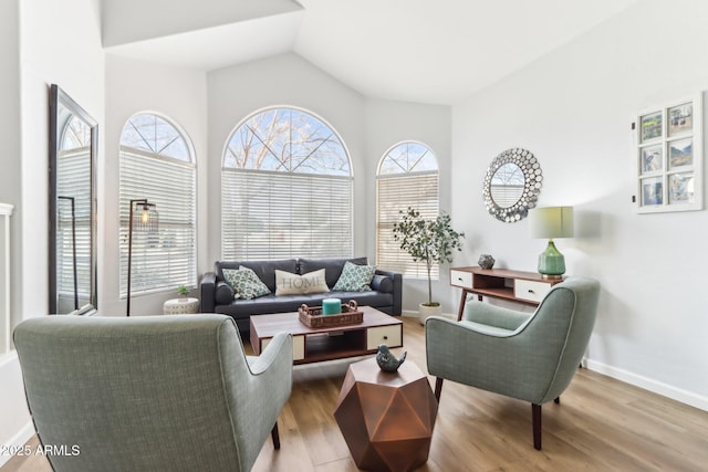 living room with lofted ceiling and light hardwood / wood-style flooring