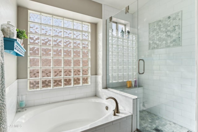 bathroom with shower with separate bathtub