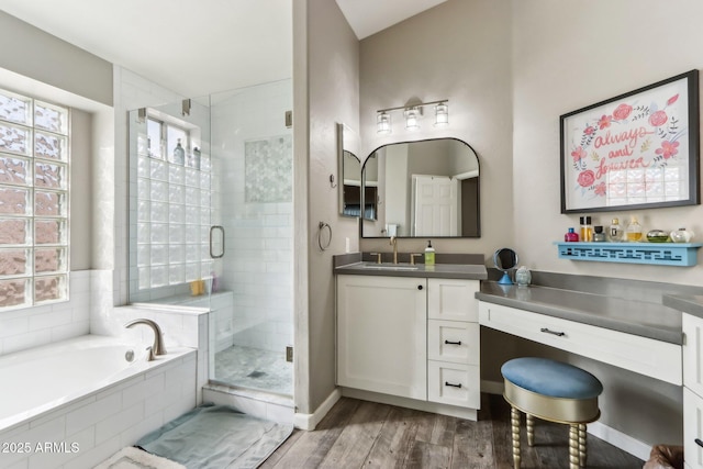 bathroom featuring hardwood / wood-style flooring, vanity, and independent shower and bath