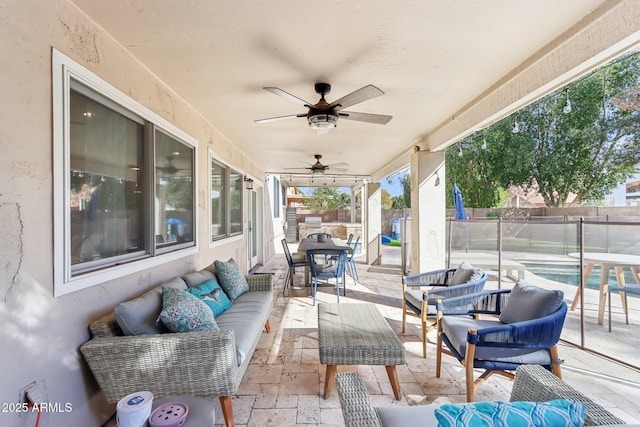 view of patio featuring ceiling fan, outdoor lounge area, and a fenced in pool