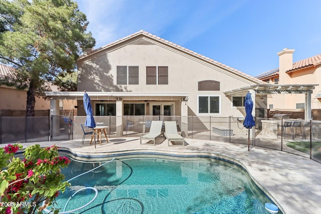 back of property featuring a fenced in pool, a patio area, and a pergola