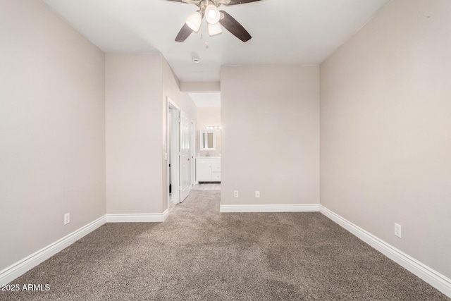 spare room with a ceiling fan, carpet flooring, and baseboards