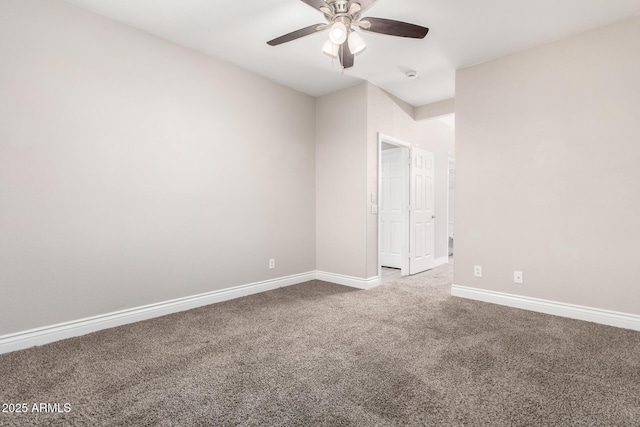 carpeted empty room with baseboards and a ceiling fan