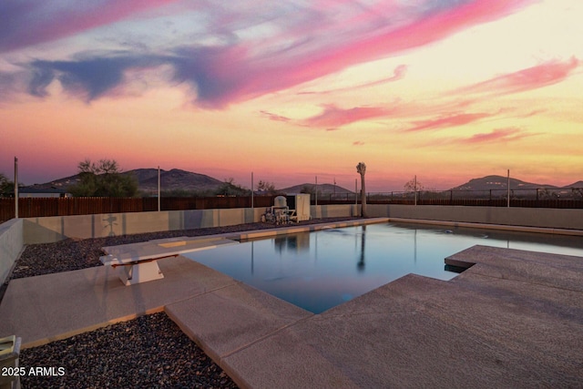 view of swimming pool featuring a fenced in pool, a fenced backyard, a patio, and a diving board