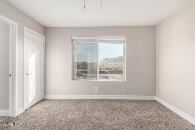 empty room with baseboards and carpet flooring