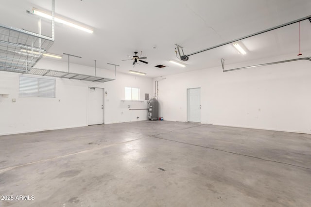 garage featuring a garage door opener and water heater