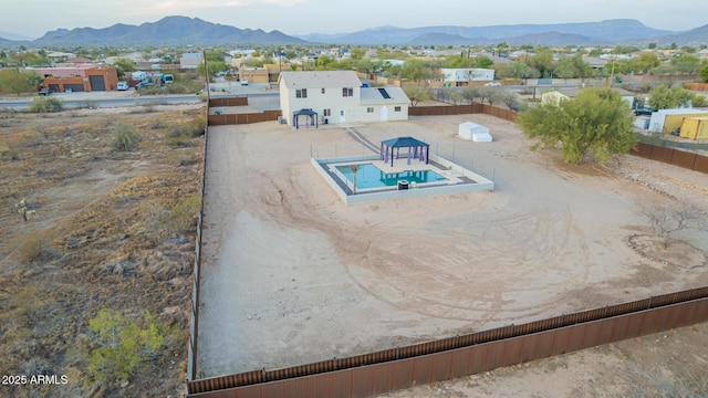 exterior space with a mountain view and fence