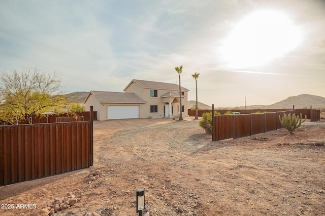 view of front of property featuring fence, driveway, an attached garage, and stucco siding