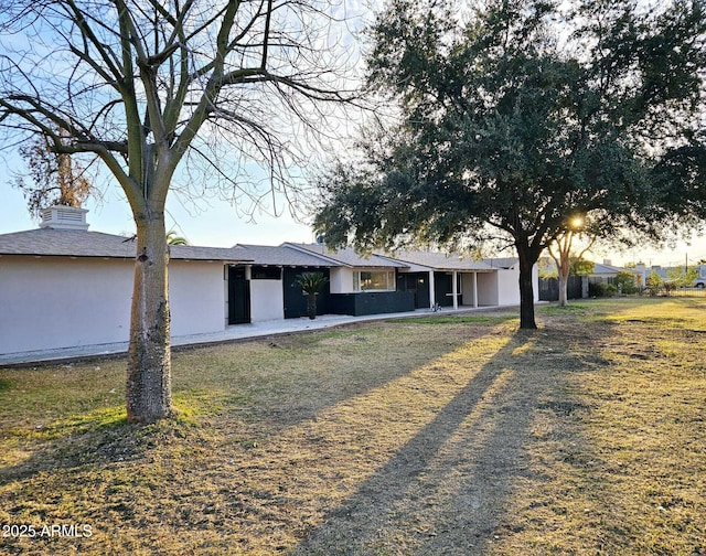 view of front of home with a sunroom and stucco siding