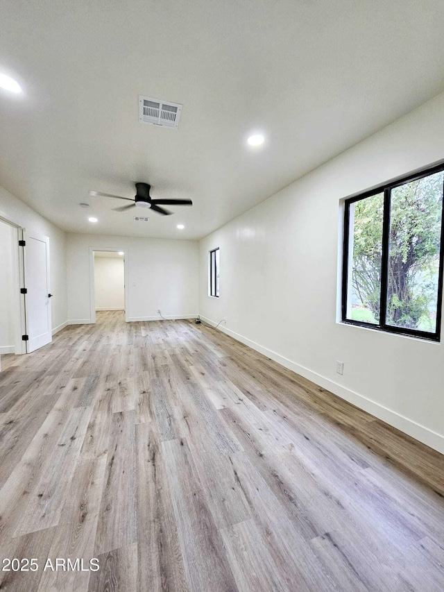 spare room featuring recessed lighting, visible vents, light wood-style flooring, and baseboards