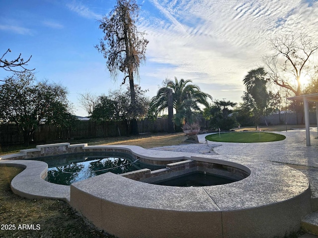 view of pool with a patio area, a fenced backyard, and a pool with connected hot tub