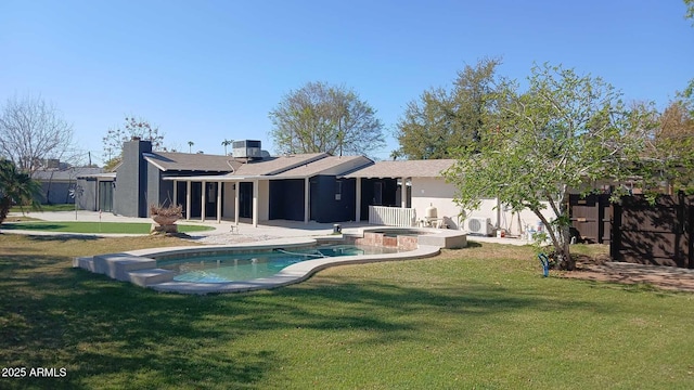 back of property featuring cooling unit, an in ground hot tub, a yard, a fenced in pool, and a patio area