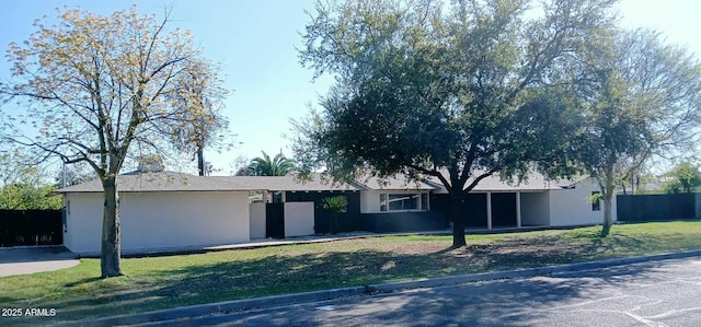 ranch-style home with stucco siding and a front yard