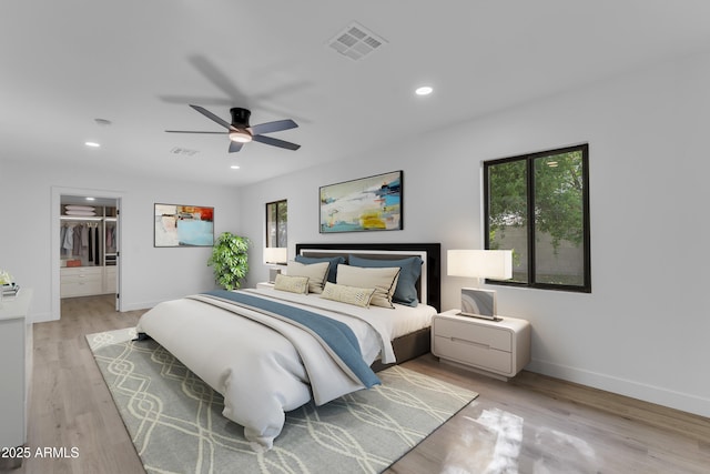 2425 E Harvard St, Phoenix, AZ 85008 - bedroom with baseboards, visible vents, recessed lighting, light wood-style floors, and a walk in closet