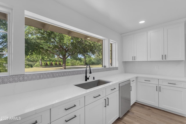 2425 E Harvard St, Phoenix, AZ 85008 - kitchen with white cabinets, recessed lighting, dishwasher, a sink, and light wood-style flooring