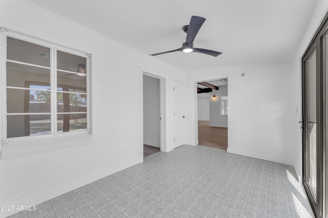 2425 E Harvard St, Phoenix, AZ 85008 - empty room featuring brick wall, a ceiling fan, crown molding, and tile patterned floors